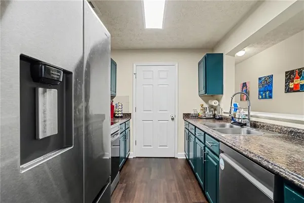 a kitchen with stainless steel appliances granite countertop a sink and a stove top oven