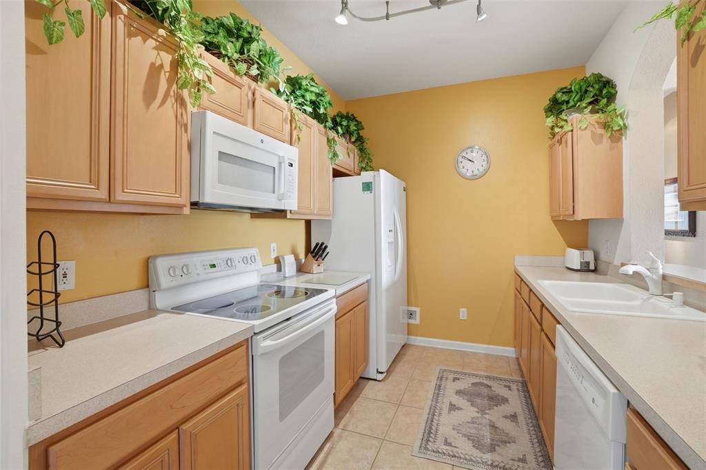 13560 Turtle Marsh Loop, Unit 336 Orlando, FL 32837 - Photo 11 of 38 a utility room with cabinets washer and dryer