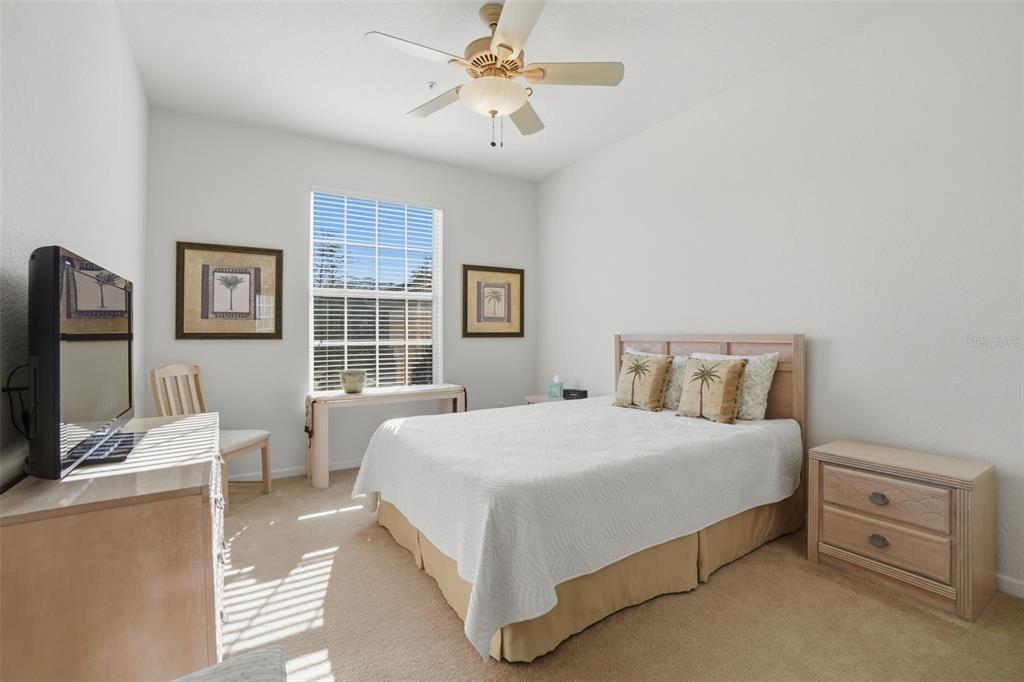 13560 Turtle Marsh Loop, Unit 336 Orlando, FL 32837 - Photo 13 of 38 a bedroom with a bed and a flat screen tv