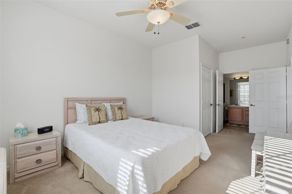 13560 Turtle Marsh Loop, Unit 336 Orlando, FL 32837 - Photo 14 of 38 a spacious bedroom with a bed and a chandelier