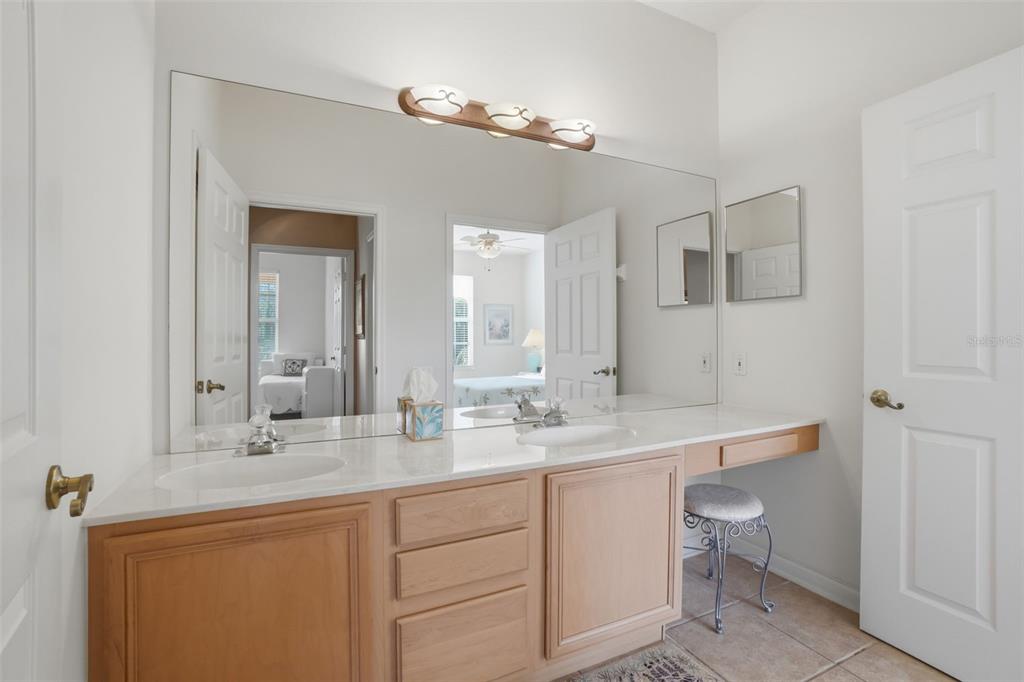 13560 Turtle Marsh Loop, Unit 336 Orlando, FL 32837 - Photo 16 of 38 a bathroom with a double vanity sink and a mirror