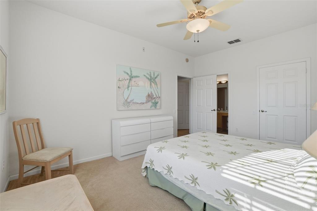 13560 Turtle Marsh Loop, Unit 336 Orlando, FL 32837 - Photo 21 of 38 a bedroom with a bed and a chair