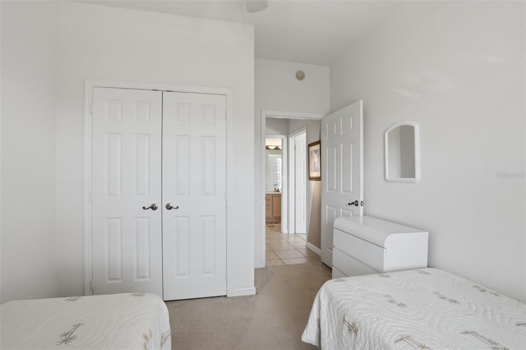 13560 Turtle Marsh Loop, Unit 336 Orlando, FL 32837 - Photo 22 of 38 a bedroom with a bed and a view of bathroom