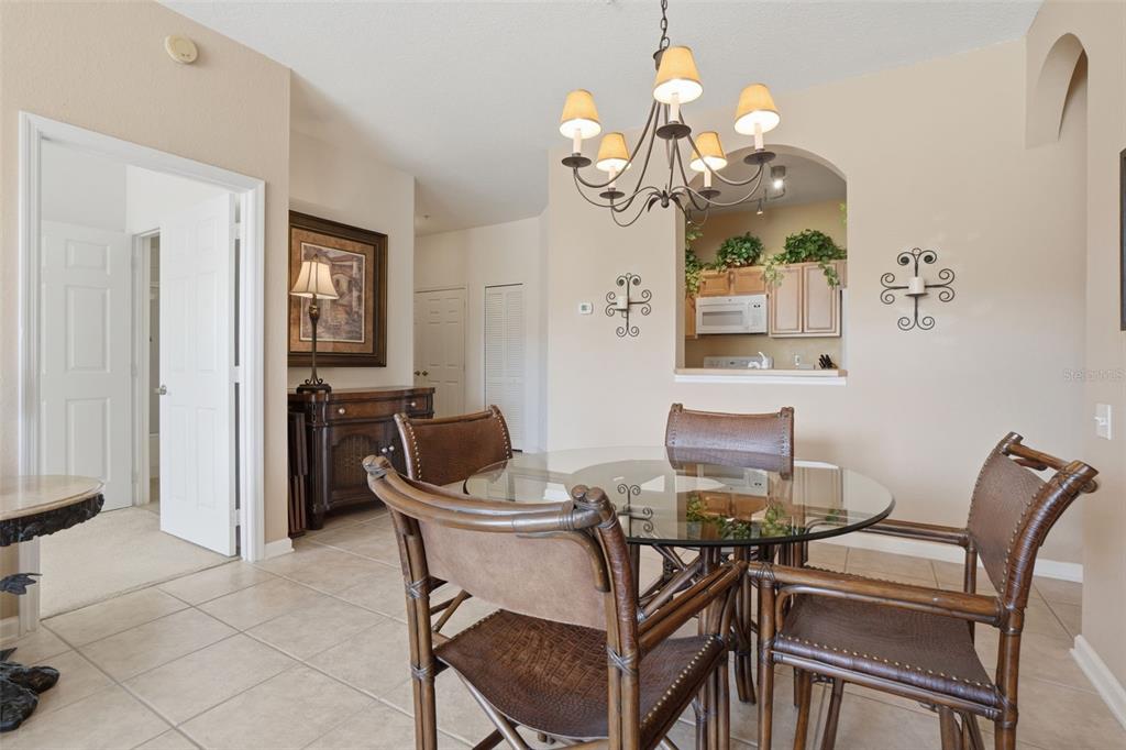 13560 Turtle Marsh Loop, Unit 336 Orlando, FL 32837 - Photo 4 of 38 a view of a dining room with furniture and chandelier