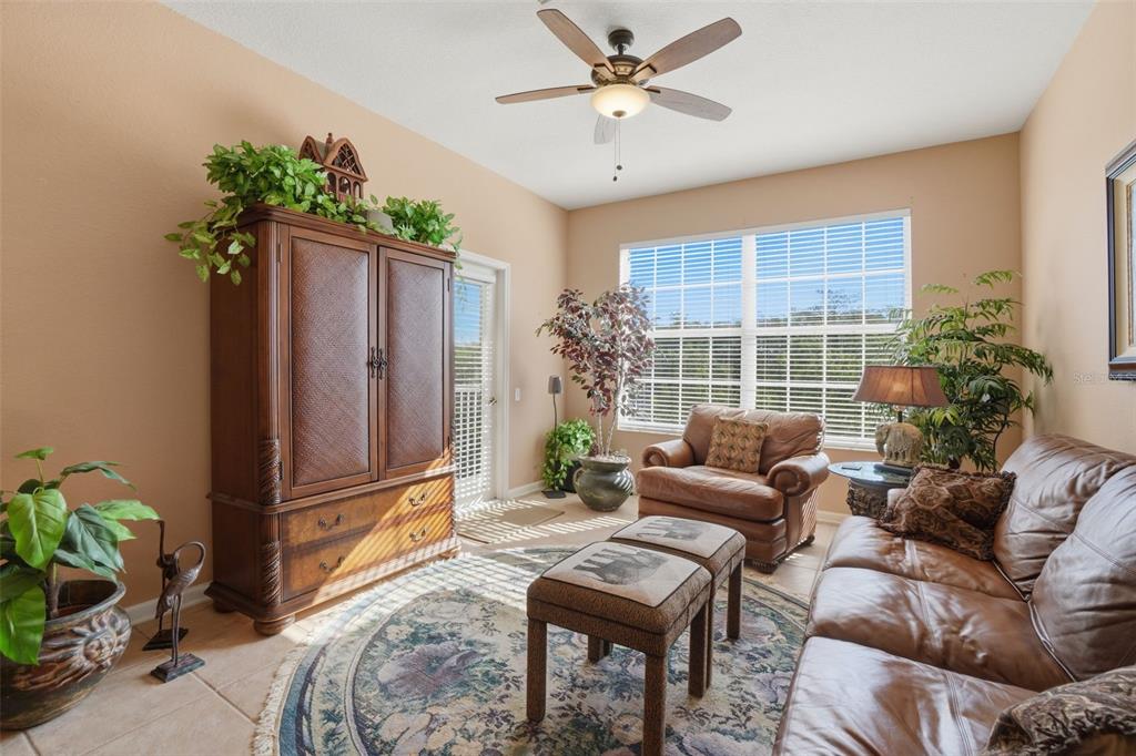 13560 Turtle Marsh Loop, Unit 336 Orlando, FL 32837 - Photo 6 of 38 a living room with furniture and a potted plant