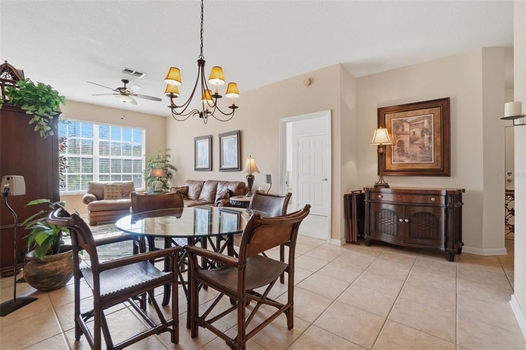 13560 Turtle Marsh Loop, Unit 336 Orlando, FL 32837 - Photo 7 of 38 a view of a dining room with furniture and chandelier