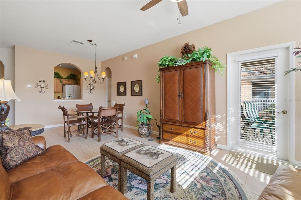 13560 Turtle Marsh Loop, Unit 336 Orlando, FL 32837 - Photo 8 of 38 a living room with furniture a window and a chandelier