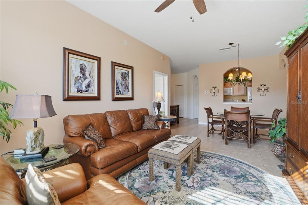 13560 Turtle Marsh Loop, Unit 336 Orlando, FL 32837 - Photo 9 of 38 a living room with furniture a chandelier and a rug