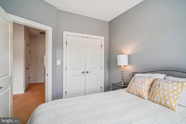 a bathroom with a sink a toilet a mirror and shower curtain