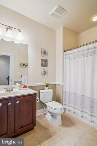 a living room with furniture a rug and a book shelf