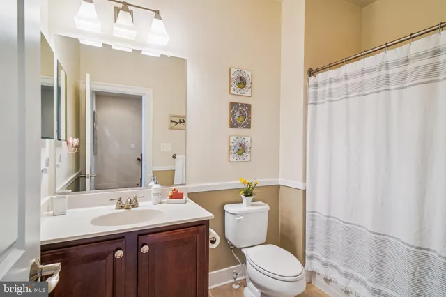 a living room with furniture a rug and a wall painting