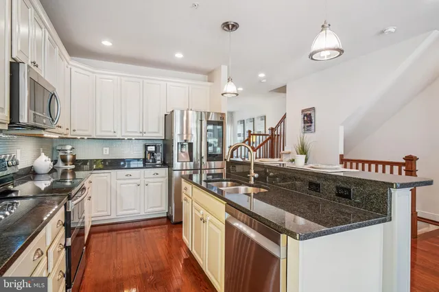 a kitchen with sink cabinets and wooden floor