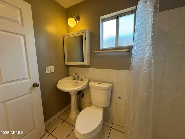a bathroom with a toilet and shower