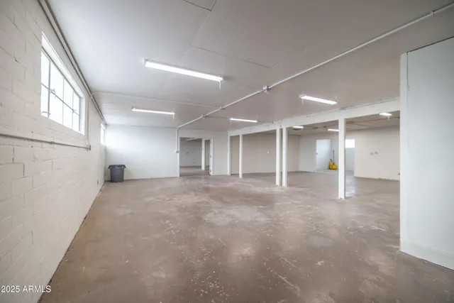 a view of empty room with a kitchen