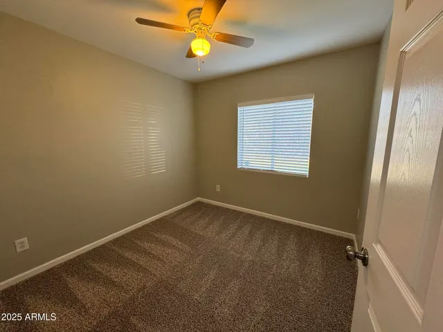 a bathroom with a toilet a sink a mirror and vanity