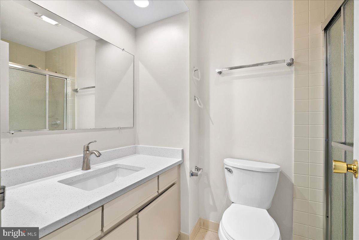 12942 A Grays Pointe Road, Unit 12942A Fairfax, VA 22033 - Photo 12 of 22 a bathroom with a sink toilet and shower