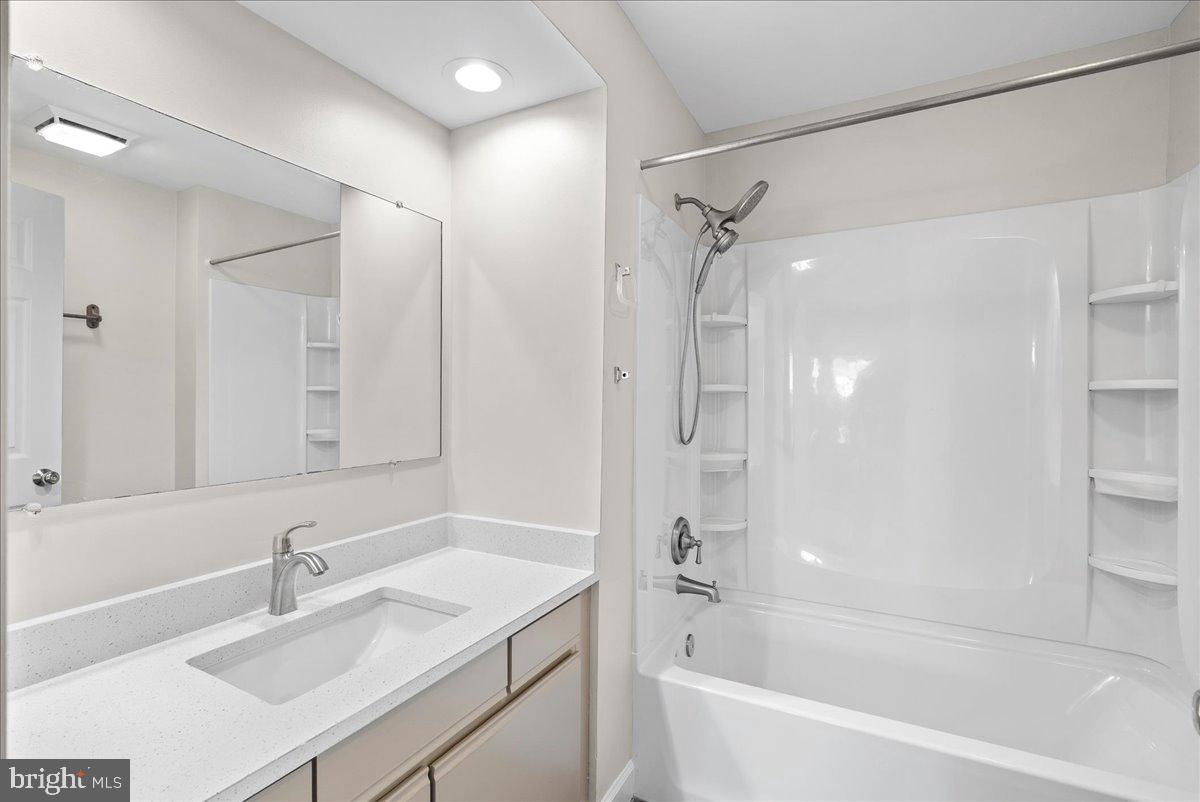 12942 A Grays Pointe Road, Unit 12942A Fairfax, VA 22033 - Photo 18 of 22 a bathroom with a bath tub sink mirror and a shower