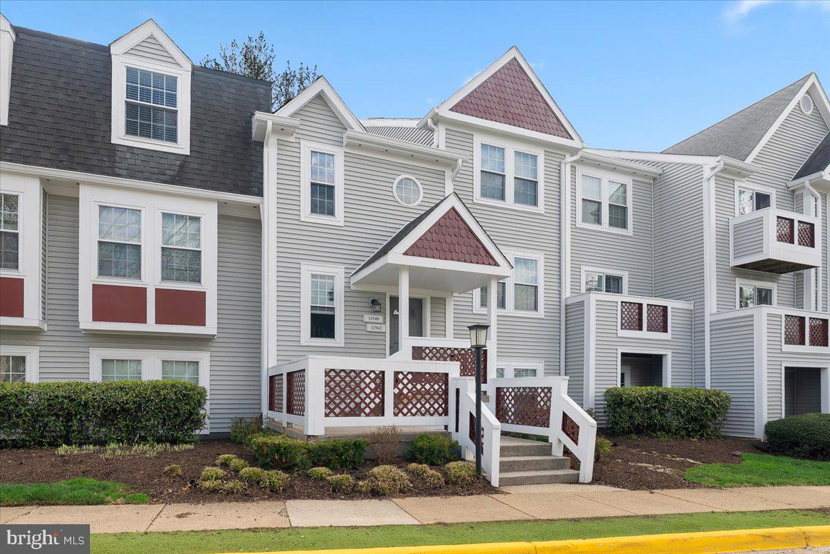 12942 A Grays Pointe Road, Unit 12942A Fairfax, VA 22033 - Photo 2 of 22 a front view of a residential apartment building with a yard