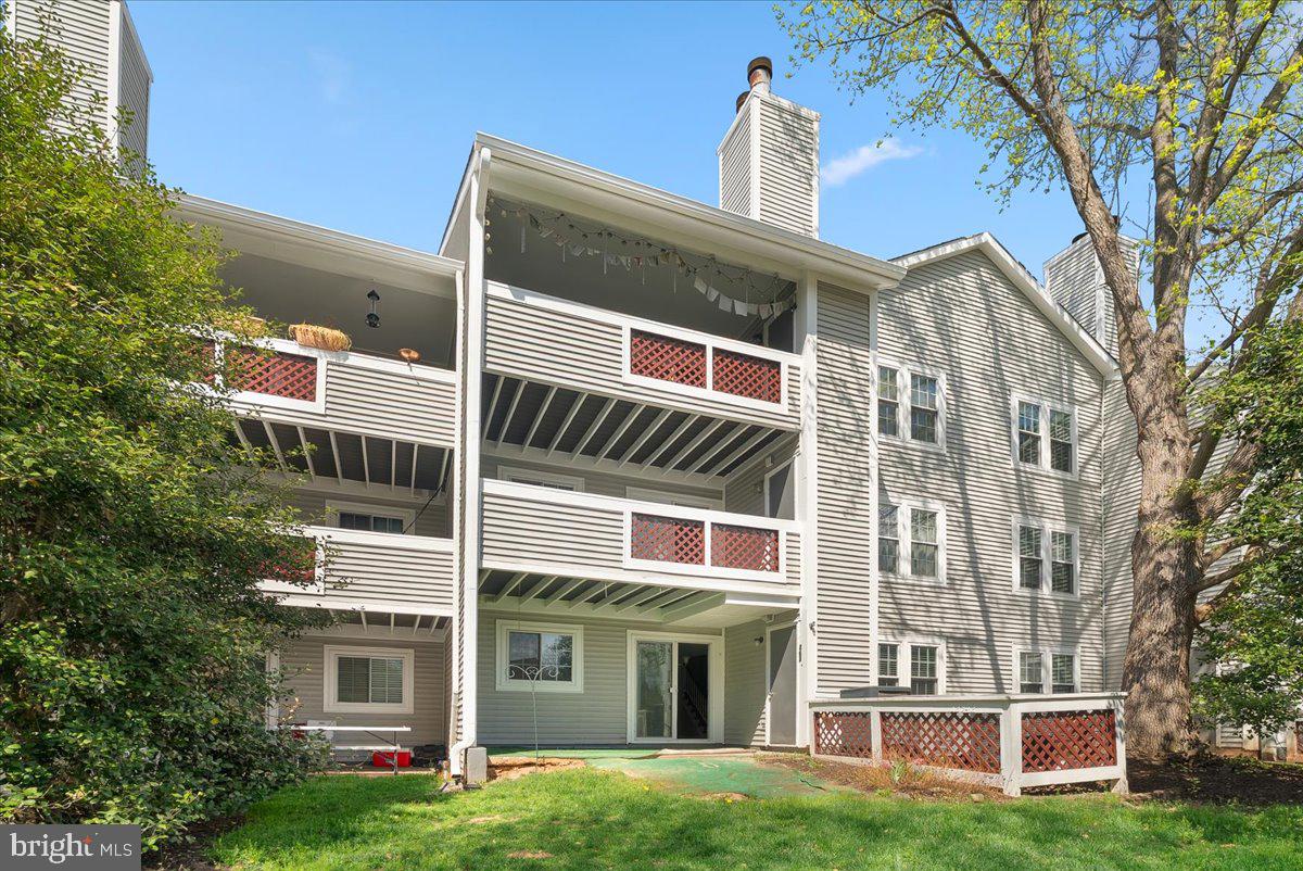 12942 A Grays Pointe Road, Unit 12942A Fairfax, VA 22033 - Photo 21 of 22 a view of a building with a yard