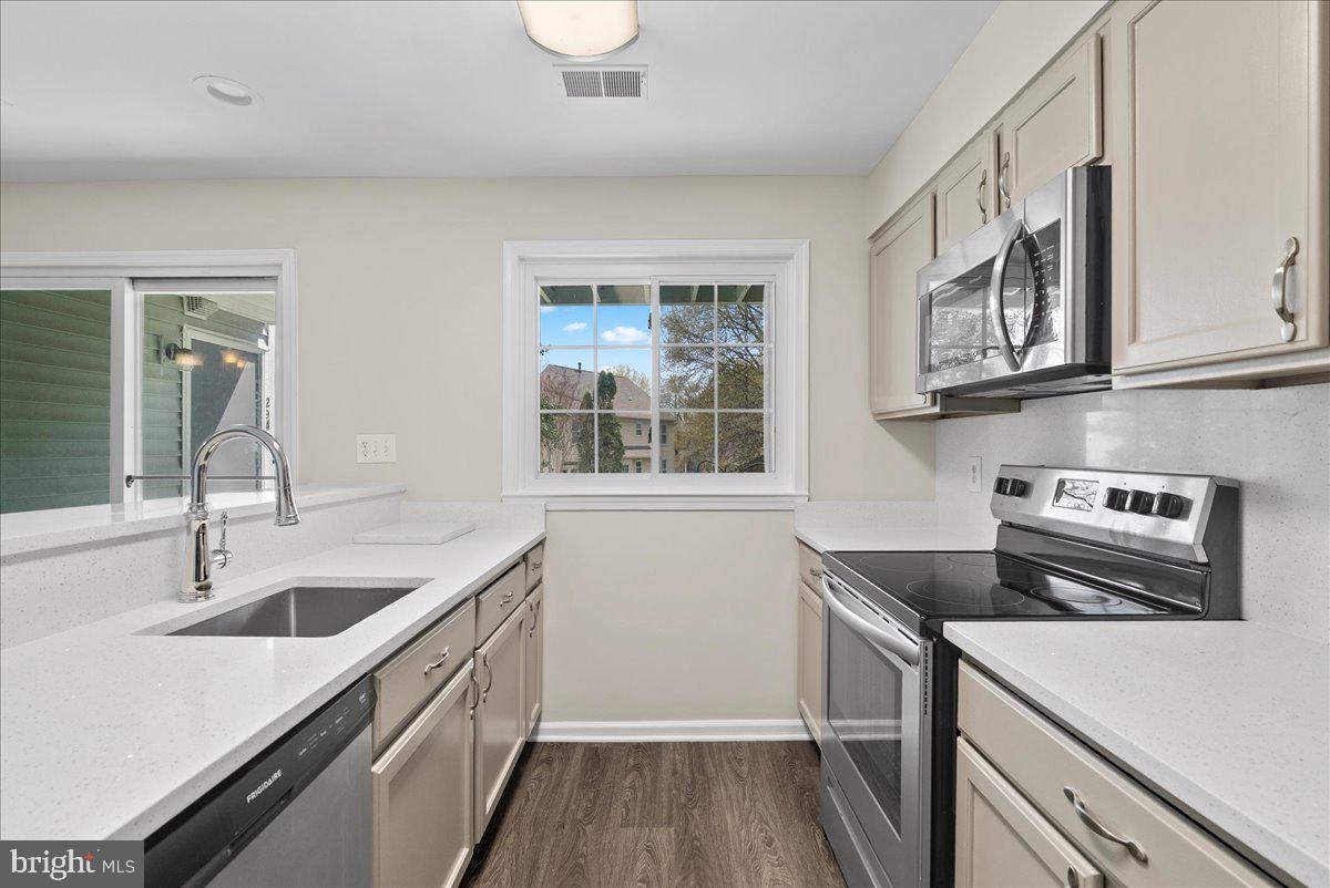 12942 A Grays Pointe Road, Unit 12942A Fairfax, VA 22033 - Photo 7 of 22 a kitchen that has a sink and a stove