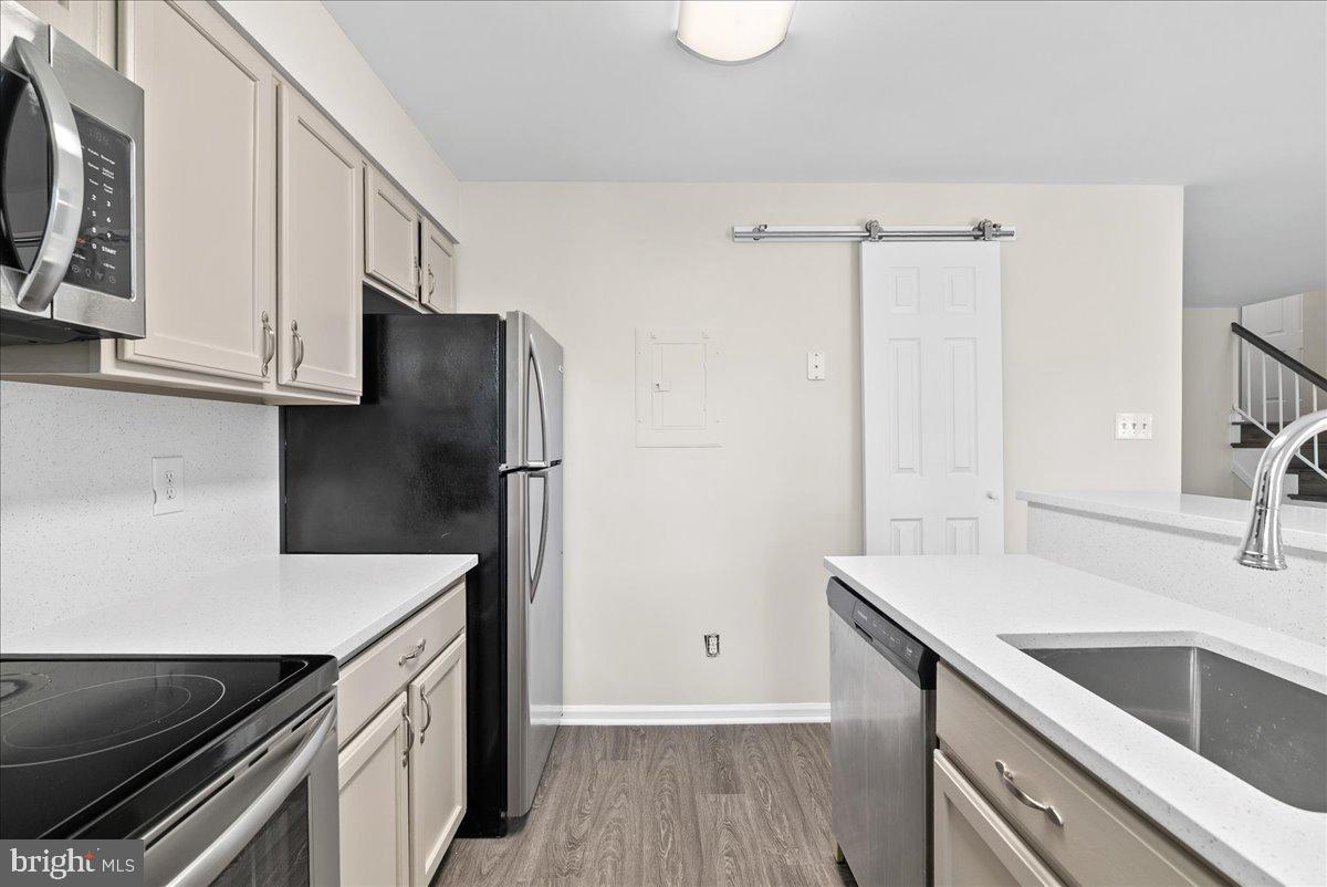 12942 A Grays Pointe Road, Unit 12942A Fairfax, VA 22033 - Photo 8 of 22 a kitchen with a sink and a refrigerator