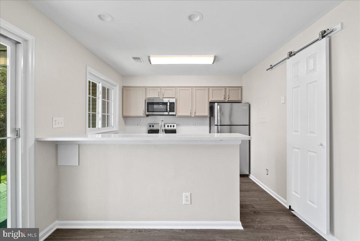 12942 A Grays Pointe Road, Unit 12942A Fairfax, VA 22033 - Photo 9 of 22 a kitchen with stainless steel appliances a refrigerator sink and microwave
