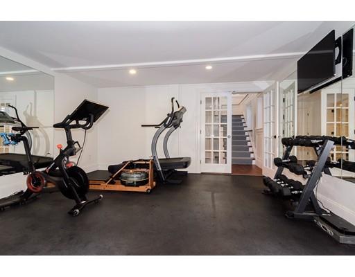 25 Kenilworth Road Wellesley, MA 02482 - Photo 27 of 28 a room with gym equipment and a flat screen tv