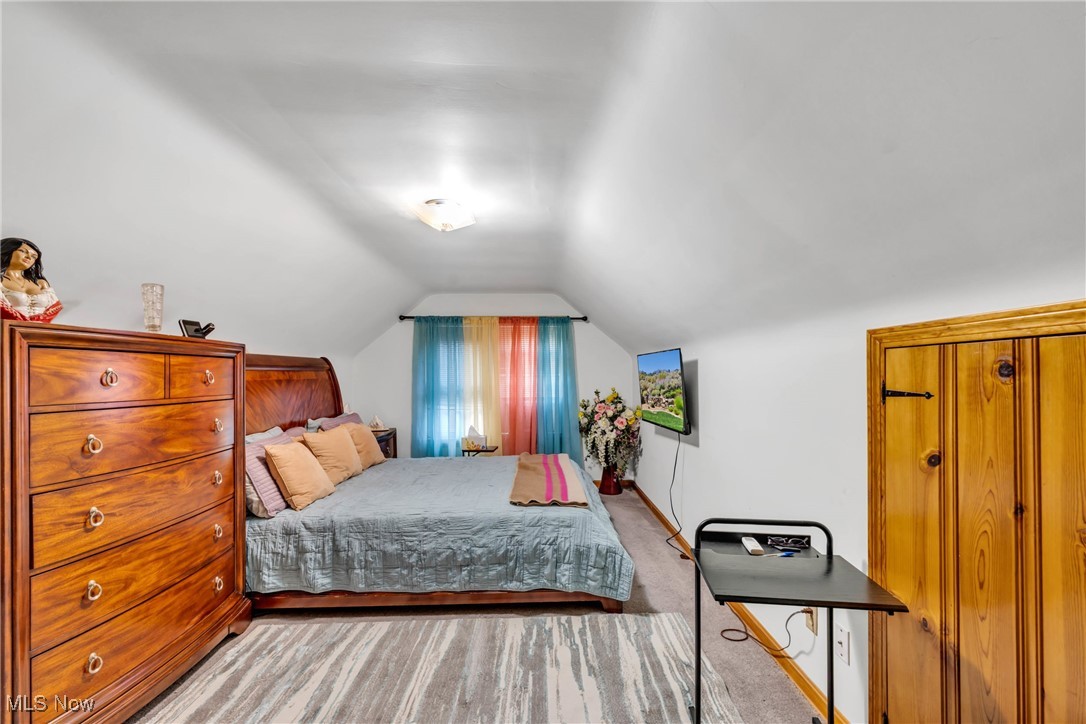 631 Trebisky Road Cleveland, OH 44143 - Photo 22 of 33 Bedroom with lofted ceiling and light carpet