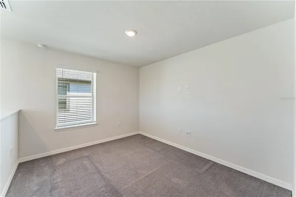 a view of a hallway with white walls