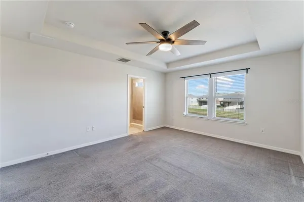 a bathroom with a granite countertop double vanity sink mirror and toilet