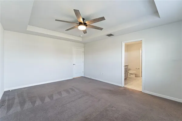 a spacious bathroom with a granite countertop sink a toilet and shower