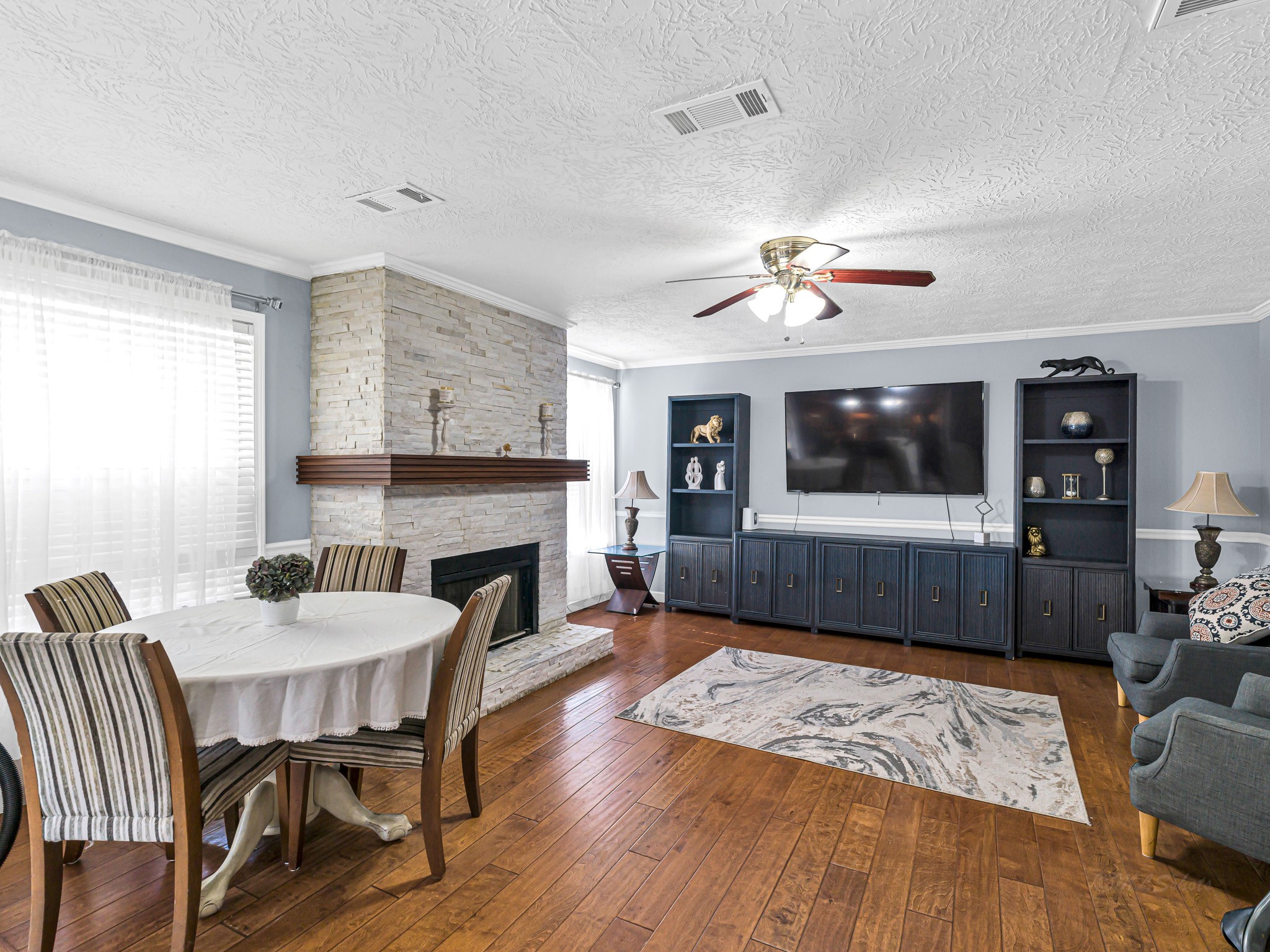 6822 Eagle Ridge Drive Katy, TX 77449 - Photo 13 of 36 a living room with furniture a flat screen tv and a fireplace