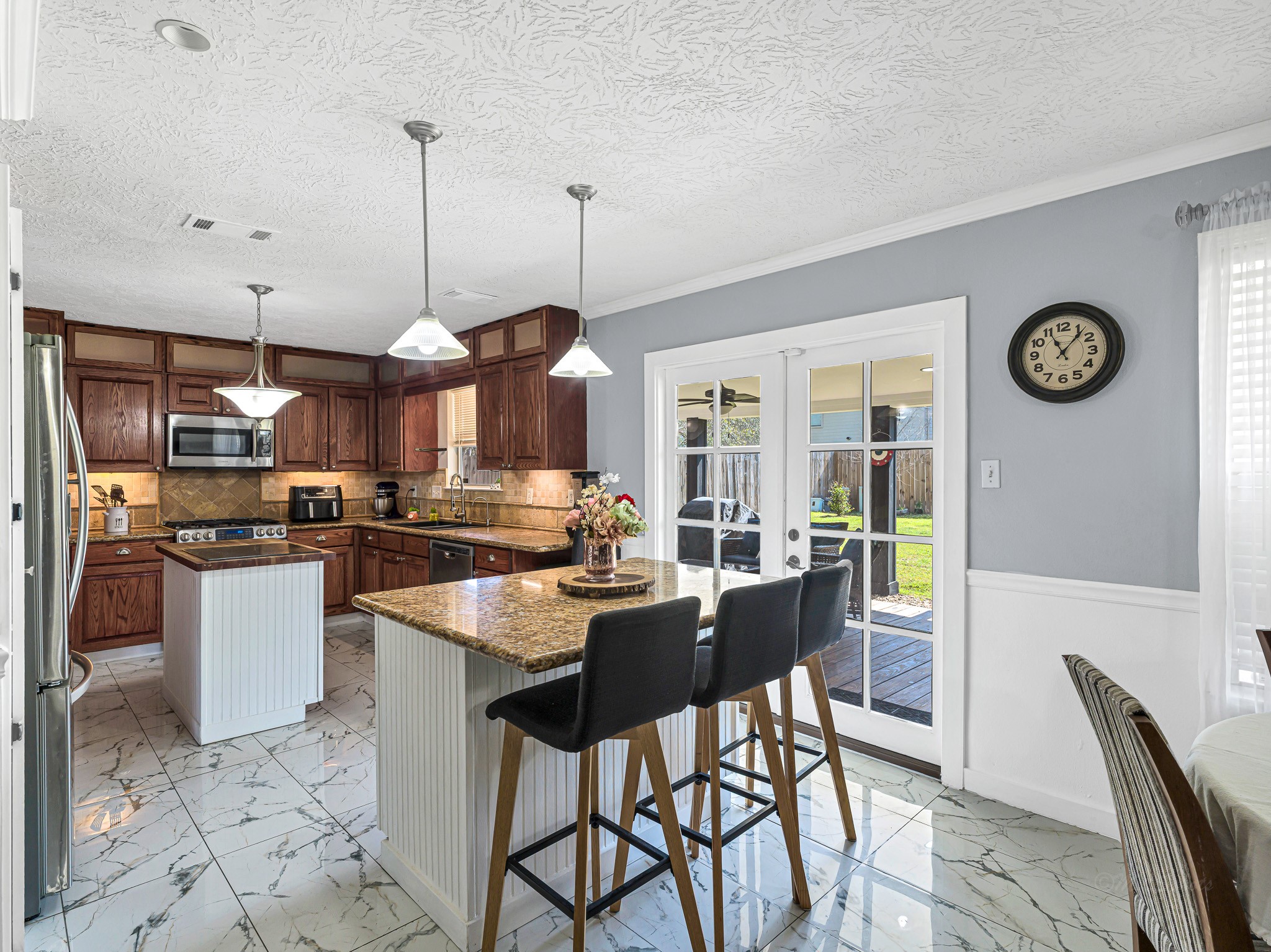 6822 Eagle Ridge Drive Katy, TX 77449 - Photo 16 of 36 a kitchen with stainless steel appliances kitchen island granite countertop a stove a sink and a refrigerator