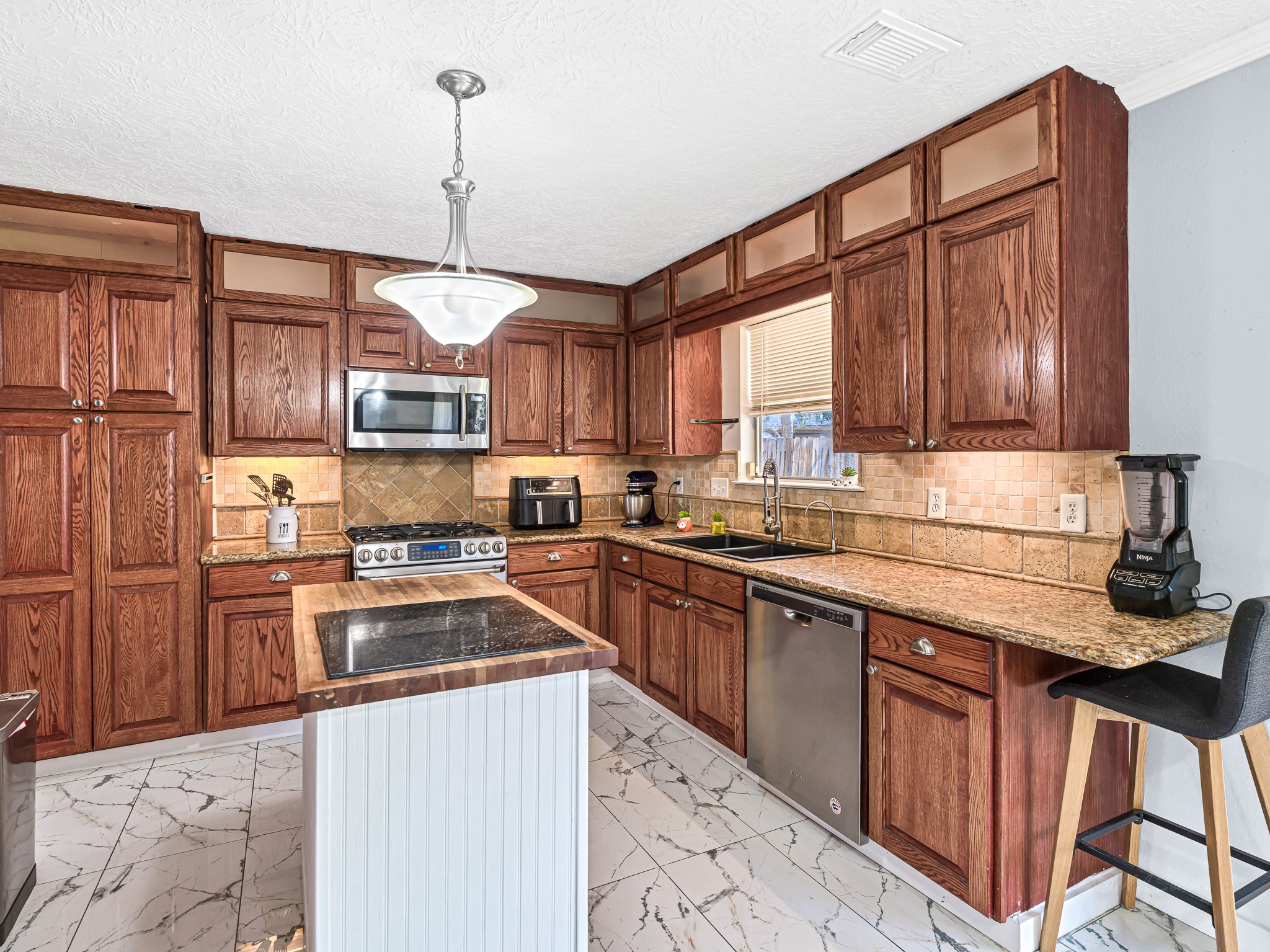 6822 Eagle Ridge Drive Katy, TX 77449 - Photo 18 of 36 a kitchen with stainless steel appliances granite countertop a stove sink refrigerator and cabinets