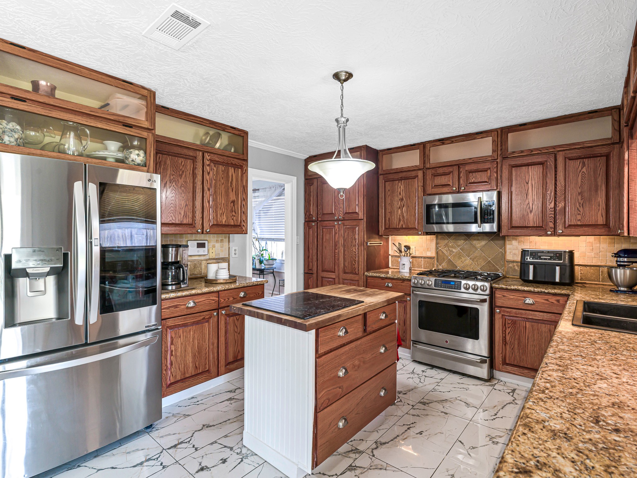 6822 Eagle Ridge Drive Katy, TX 77449 - Photo 19 of 36 a kitchen with stainless steel appliances granite countertop a stove a sink dishwasher a refrigerator and a oven with wooden floor