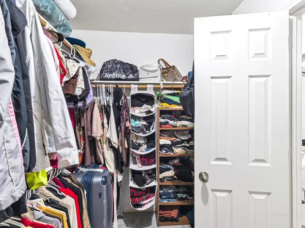 a view of walk in closet with clothes