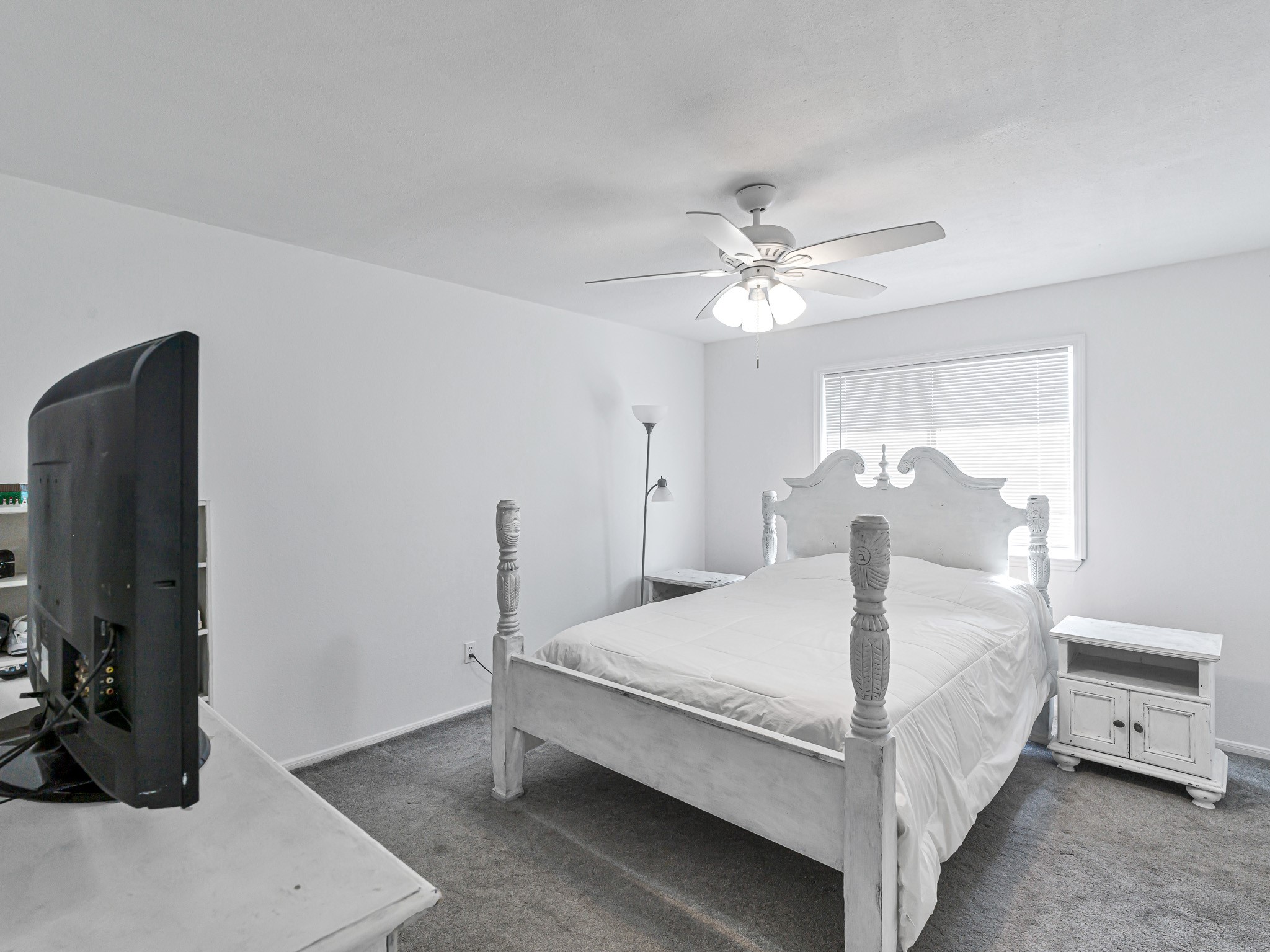 6822 Eagle Ridge Drive Katy, TX 77449 - Photo 27 of 36 a bedroom with a bed and a chandelier