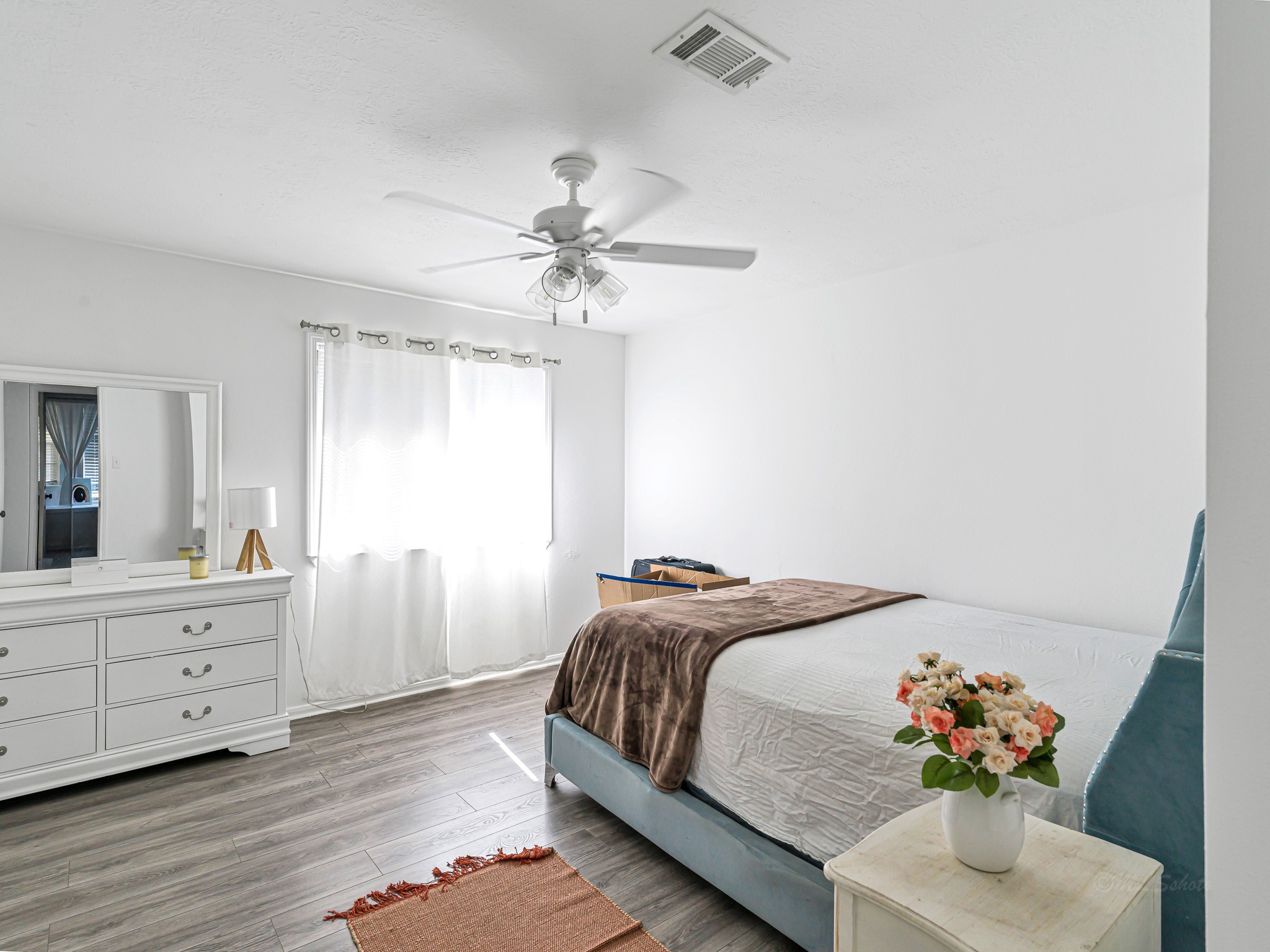 6822 Eagle Ridge Drive Katy, TX 77449 - Photo 28 of 36 a bedroom with a white bed and a chandelier