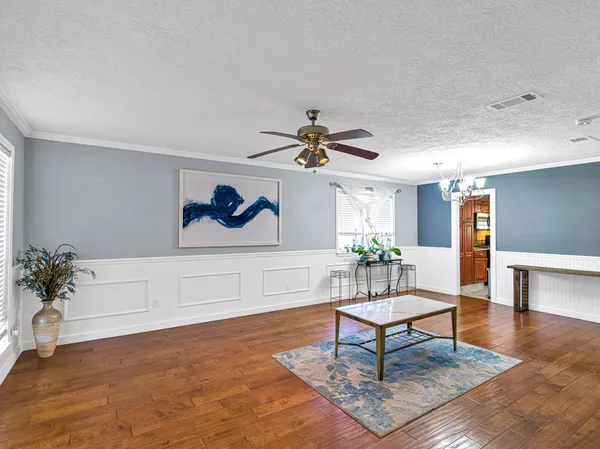 a living room with furniture and a potted plant