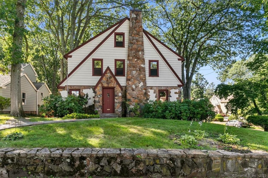 a view of a house with a yard and potted plants