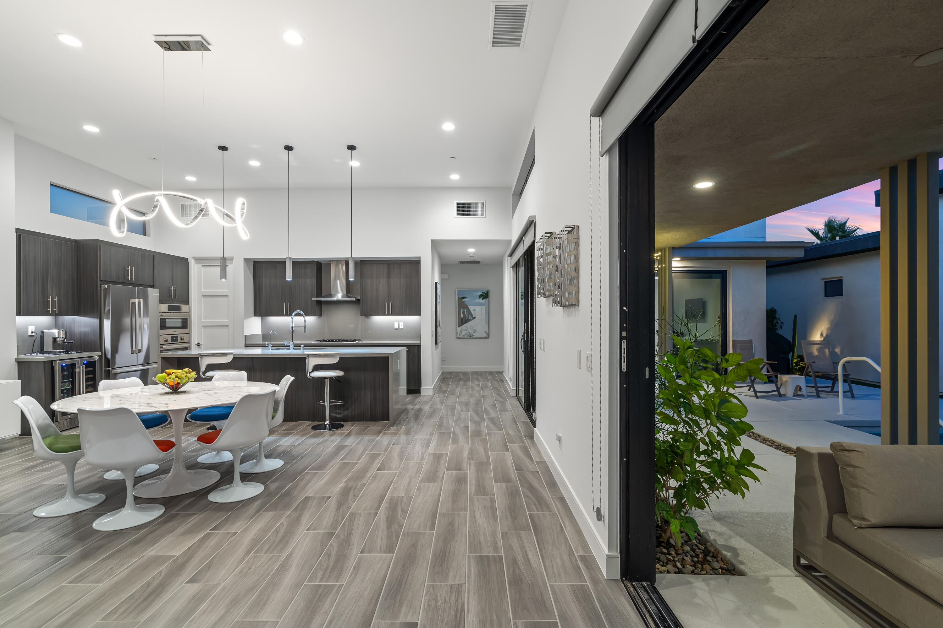 175 Vibe Way Palm Springs, CA 92262 - Photo 5 of 42 a kitchen with stainless steel appliances granite countertop a refrigerator oven a sink dishwasher and couches with wooden floor