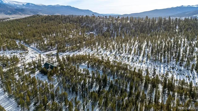 a view of mountain with sunset in background