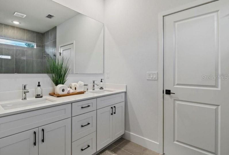 5550 Southwest 107th Street Ocala, FL 34476 - Photo 13 of 15 a bathroom with a granite countertop sink and a mirror