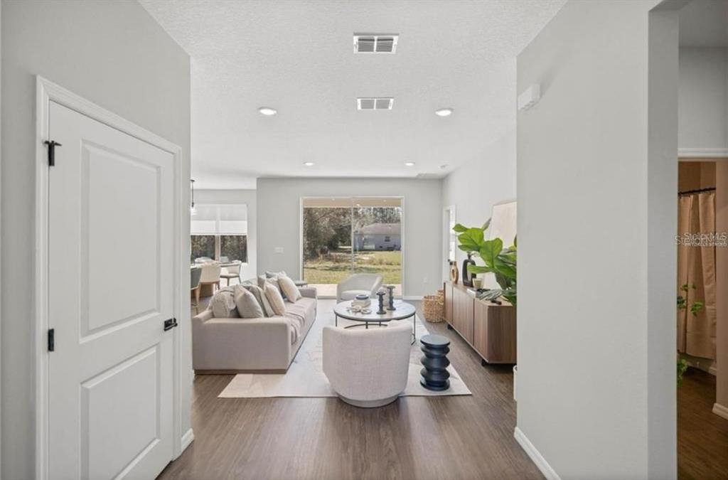 5550 Southwest 107th Street Ocala, FL 34476 - Photo 7 of 15 a living room with furniture and a potted plant