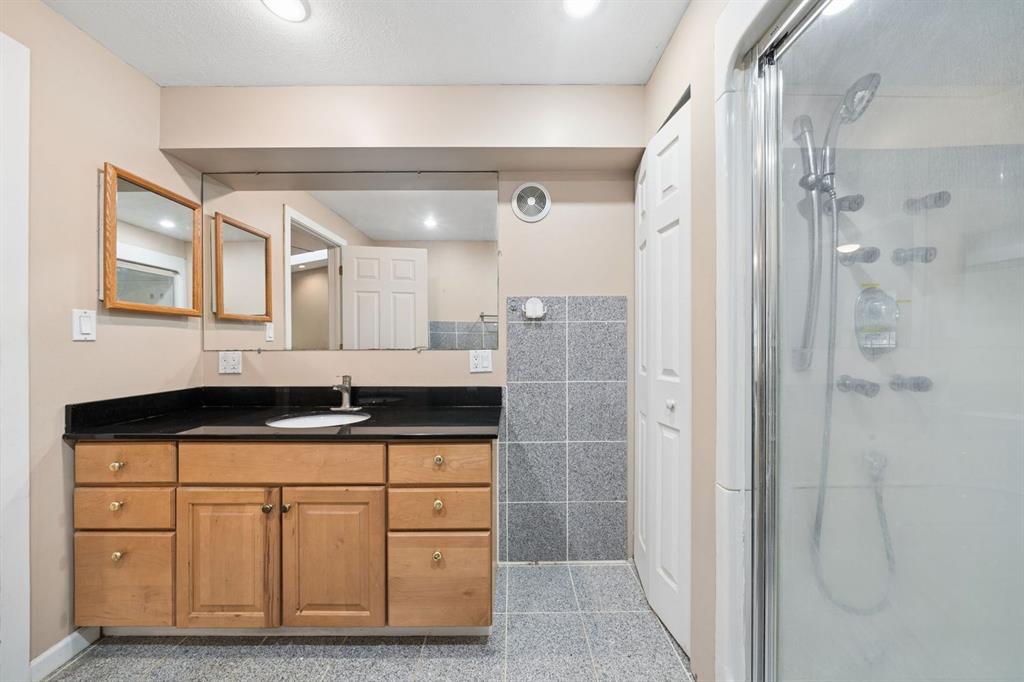 446 Diablo Drive Pittsburgh, PA 15241 - Photo 22 of 39 a bathroom with a granite countertop sink a mirror a vanity and a shower