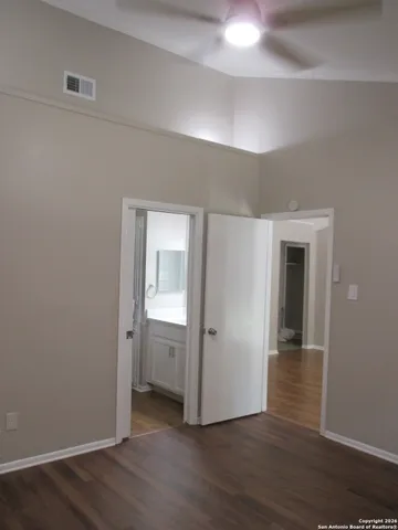 an empty room with wooden floor and closet