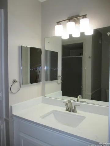 a bathroom with a sink and a mirror