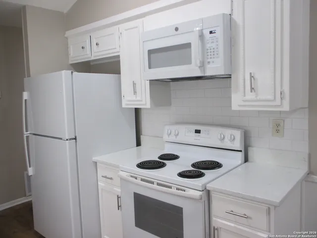 a kitchen with a stove and a refrigerator