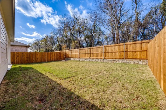 a view of backyard with large trees