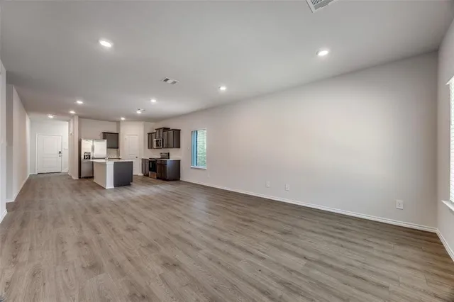a kitchen with sink stove and refrigerator